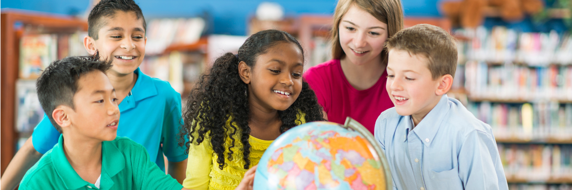 Children in a group around a globe