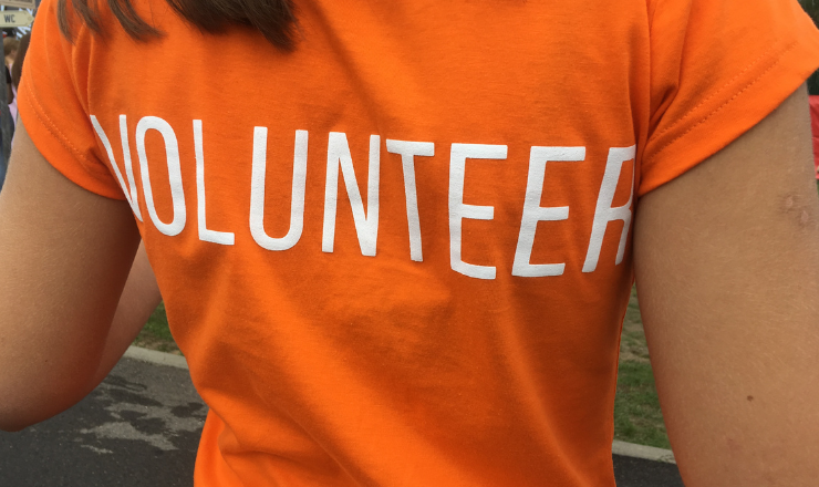 Person in orange volunteer shirt