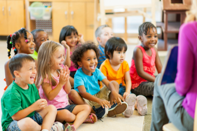 Photo of children sitting on floor listening to storytime.