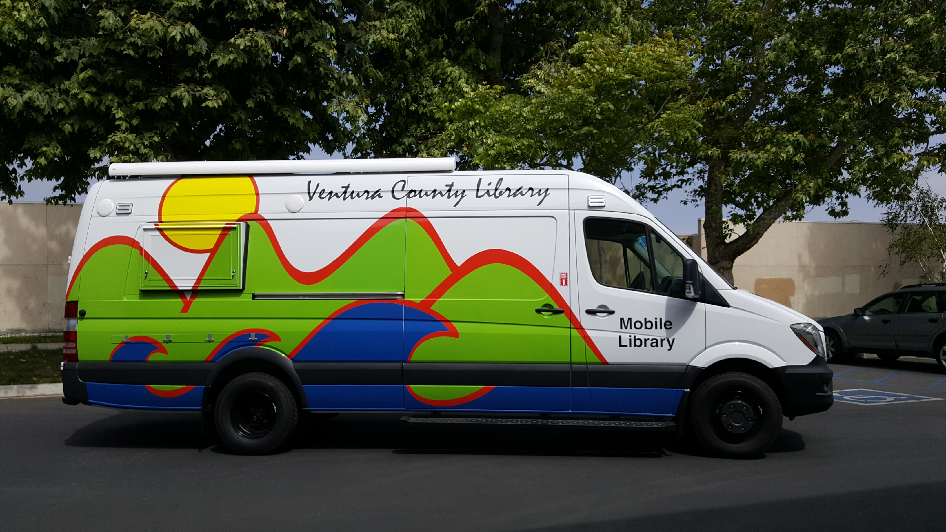 Ventura County Mobile Library photo - a large while van with the VCL mountains, sea, and sun logo on the side