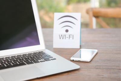 Library Service - Wi-Fi - laptop on desk with phone and wifi sign