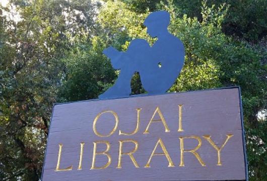 The Ojai Library sign features a silhouette of a young boy reading.