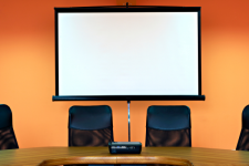 Library Service - Meeting Rooms - Conference room with screen and table with chairs