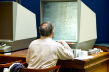 Library Service - Microfilm Reader Man using microfilm reader