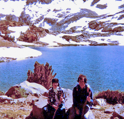 Joel and little brother in 1983 in front of lake with snow in the background.