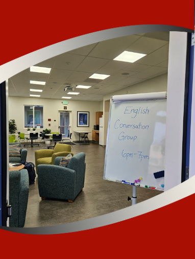 room with couches, tables and chairs and whiteboard that reads English Conversation Group