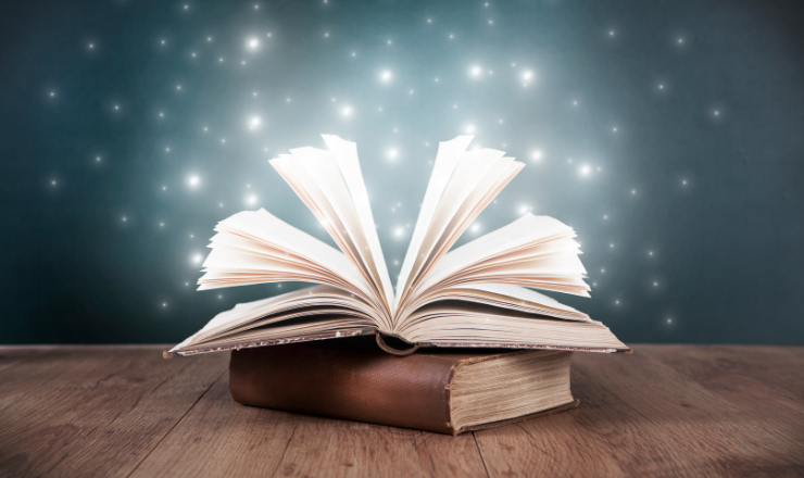 Open book with shining stars coming from the pages. 