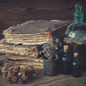 A graphic of old books, bottles, and herbs.