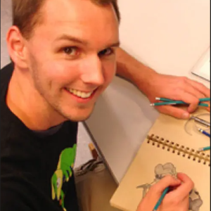 Kyle smiling at camera and drawing