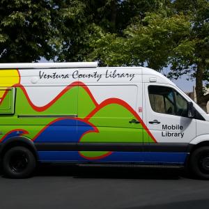 Ventura County Mobile Library photo - a large white van with the VCL mountains, sea, and sun logo on the side