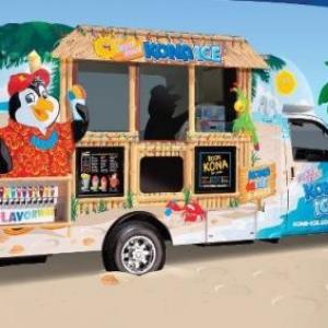 shaved ice truck with cartoon penguin on the side, parked on a beach